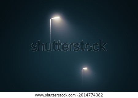 Street lights in the misty evening glowing in the dark by midnight Royalty-Free Stock Photo #2014774082