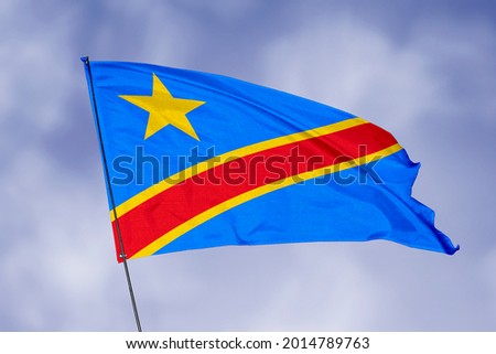 Dr Congo flag isolated on sky background. National symbol of Dr Congo. Close up waving flag with clipping path.