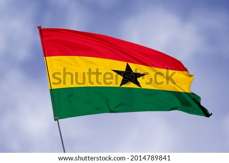 Ghana flag isolated on sky background. National symbol of Ghana. Close up waving flag with clipping path.