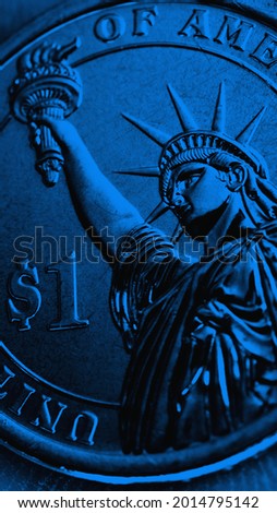 US coin lies on the palm. Deep blue tinted mobile phone wallpaper. Dark narrow vertical background about economy, finance or banking. 1 one dollar coin close-up. The Statue of Liberty. Macro