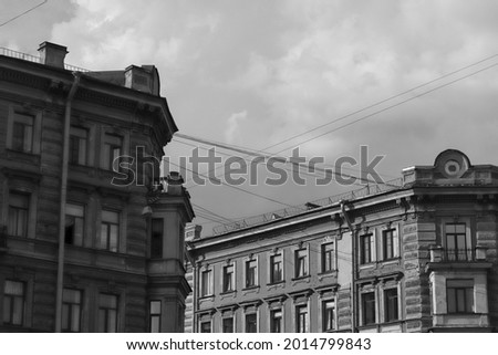 The monochrome picture of the sky and a facade of an old building in Saint Petersburg