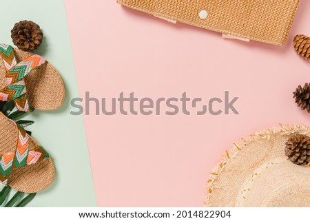 Creative flat lay of travel vacation spring or summer tropical fashion. Top view beach accessories on pastel green pink color background with blank space for text. Top view copy space photography.