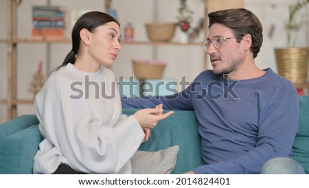 Attractive Mixed Race Couple having Conversation at Home 