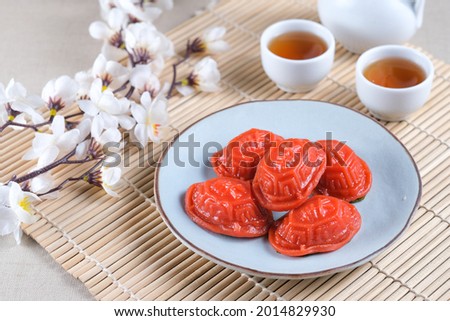 Kue Ku or tok cake or red turtle cake is Indonesian traditional cake from Chinese culture made from glutinous rice and sweet green bean inside, in the shape of a turtle shell. Selective focus. Royalty-Free Stock Photo #2014829930