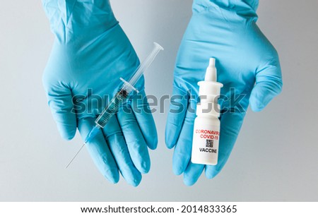 intranasal and liquid covid vaccine in the nurse's hand