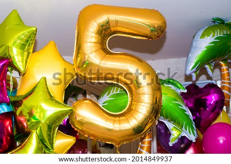 festive composition of balloons. golden number 5. multicolored stars, hearts, round balls.