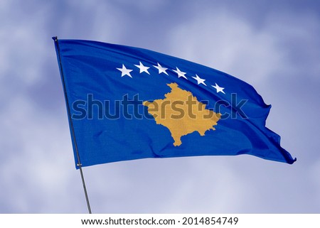 Kosovo flag isolated on sky background. National symbol of Kosovo. Close up waving flag with clipping path.