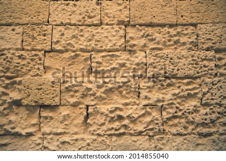 Close shot to bricks of ancient walls in Leccese stone characteristic for its tenderness and friability, very evident signs of the erosion of time. Royalty-Free Stock Photo #2014855040