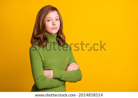Photo portrait girl serious face crossed hands isolated vibrant yellow color background copyspace