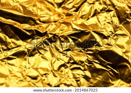 Crumpled golden foil as background