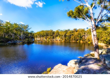 Sandstone boulders on Lake Parramatta waterfront on a sunny day - Greater sydney nature reserve. Royalty-Free Stock Photo #2014870025