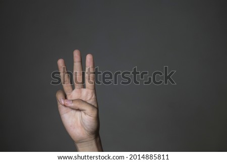 southeast asian male hand gesture on gray background