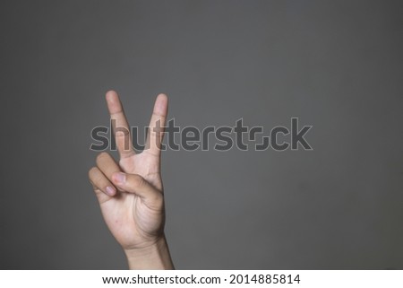 southeast asian male hand gesture on gray background