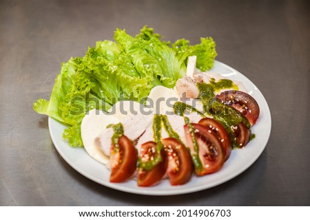 Fresh freshly prepared salad with tomatoes, herbs and meat