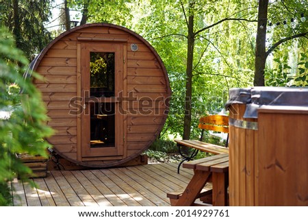 outdoor wooden barrel sauna in the garden Royalty-Free Stock Photo #2014929761