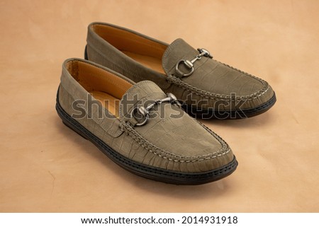 Gray bit loafers made from alligator texture leather for preppy formal mens shoes. Royalty-Free Stock Photo #2014931918
