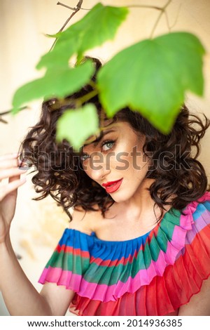 Beautiful woman in the flowers dress in summer city