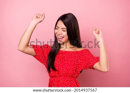 Portrait of attractive lucky dreamy cheerful girl dancing having fun isolated over pink pastel color background