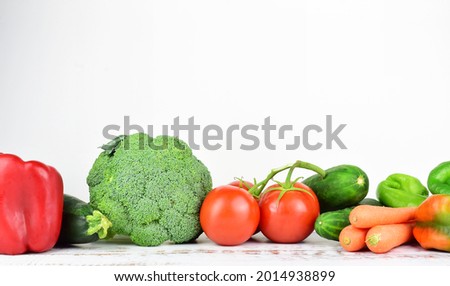 Healthy food, fresh assorted vegetables and tomatoes, isolated, on white background and copy space.