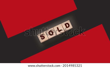 Sold Word Written In Wooden Cubes on black background. Real estate business concept