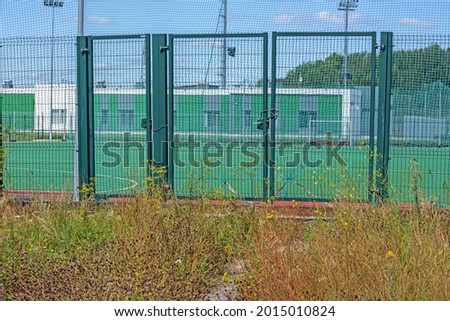 Spare gates of the sports stadium on a summer day