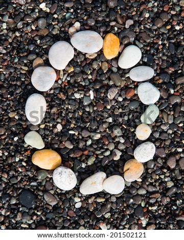 English letters of alphabet  laid on a black sand