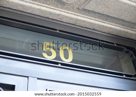 building entrance on the street indicating number 50