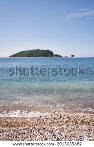 View from the pebble beach to the island of St. Nicholas. Budva, Montenegro