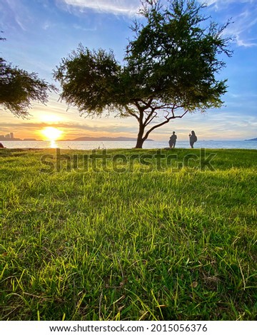 Family enjoying the sunset at Teluk Likas Kota Kinabalu, Sabah Malaysia