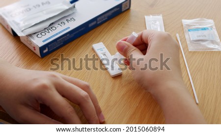 Close-up face of young adult asia woman people use auto PCR cotton self cure kit from hospital clinic service by telehealth telemedicine call support in cold flu virus health care isolate at home. Royalty-Free Stock Photo #2015060894