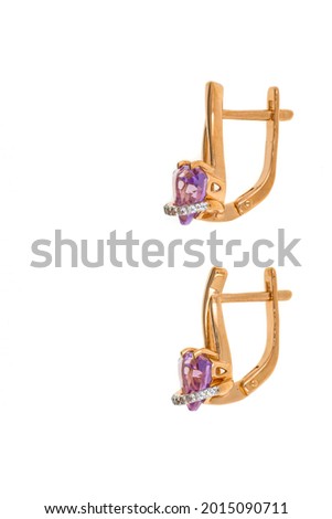 Gold earrings with a pink stone. The jewelry is isolated on a white background