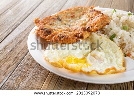 A view of a plate of tortang dulong, also known as deep fried silverfish, with fried eggs.
