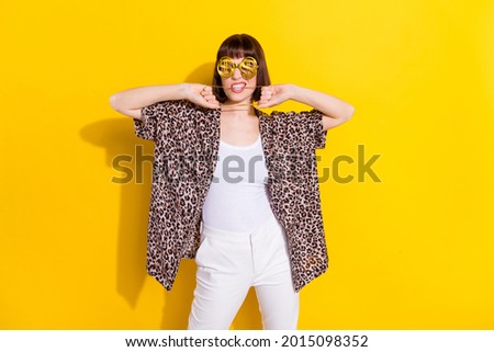 Photo of wealthy millennial young lady bite chain wear eyewear accessories leopard shirt isolated on yellow color background