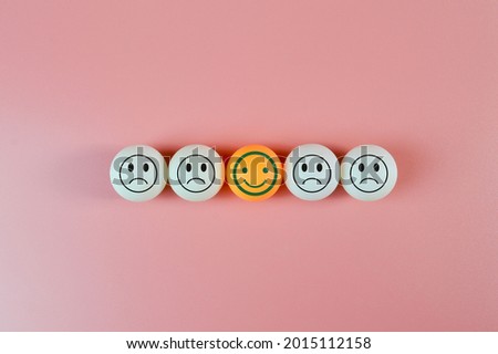 Table tennis ball with sad and happy face emotion. Customer evaluation and satisfaction concept.