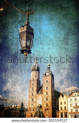 The main square of Krakow with a street lamp and a church on a grungy background