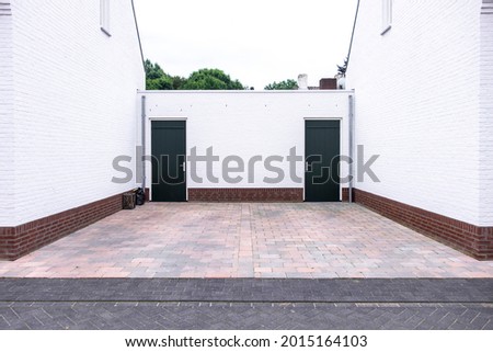 Symmetrical garage entry with white walls.