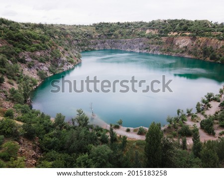 overhead top view of flooded mine lake with blue water copy space