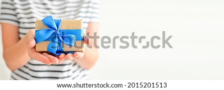 Happy father's day. Hands of young woman hold a beautiful gift on a white background close-up. Soft focus. I love you. Love and health in the family. copyspace