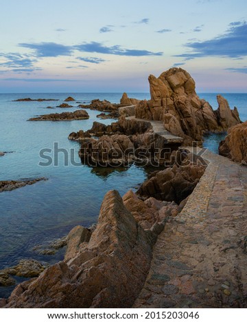 landscape of rocky beach at the blue hour in catalonia