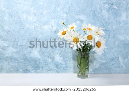 Bouquet with daisies in a vase.Abstract flower composition, autumn background, minimal holiday concept. Mother's day card, happy birthday, wedding, place for text, selective focus