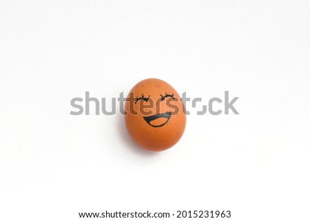a brown chicken eggs with happy face isolated on white background.