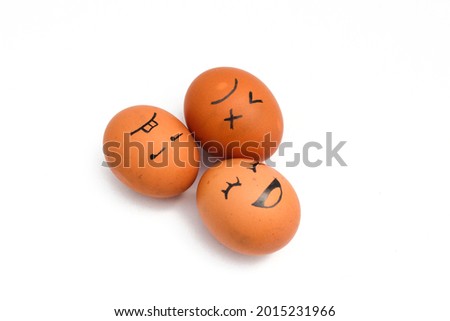 a Group of brown chicken eggs with happy, annoyed, and tired faces isolated on white background.