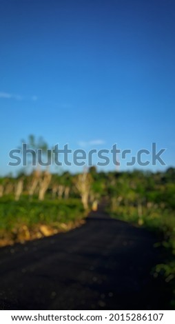 an unfocused abstract background of a paved road that climbs the high hills of Sumenep, Madura Indonesia.