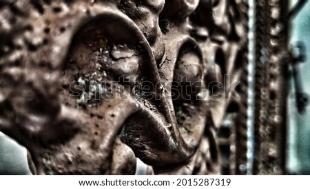 Dramatic photo plant, vintage and monocrome effect Iron carving of a circular house fence with worn brown paint, aesthetically pleasing old building art