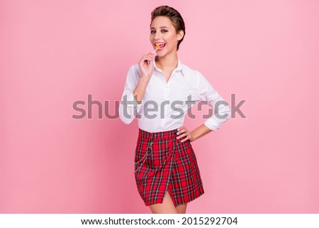 Photo of positive happy cheerful positive woman lick lollipop candy good mood isolated on pink color background