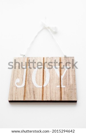 White Joy sign on wood background.