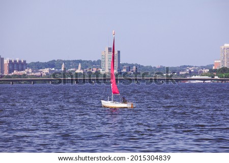 Sailing on the Charles river on a windy day with the Boston skyline in the background