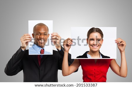 Man holding a portrait of another smiling person