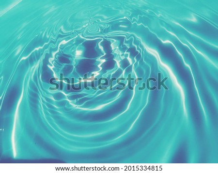Reflection​ on surface​ blue​ water​ in​ the​ swimming​ pool​ for​ graphic​ design. Abstract​ of​ surface​ blue​ water​ for​ background.