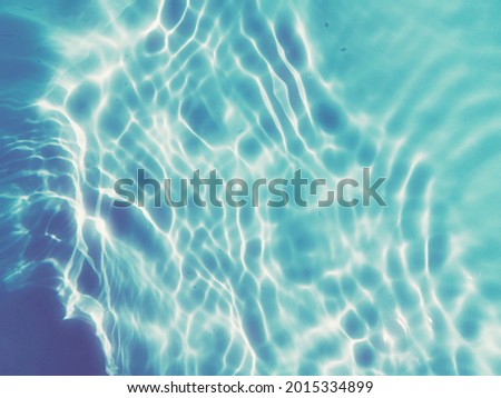Reflection​ on surface​ blue​ water​ in​ the​ swimming​ pool​ for​ graphic​ design. Abstract​ of​ surface​ blue​ water​ for​ background.